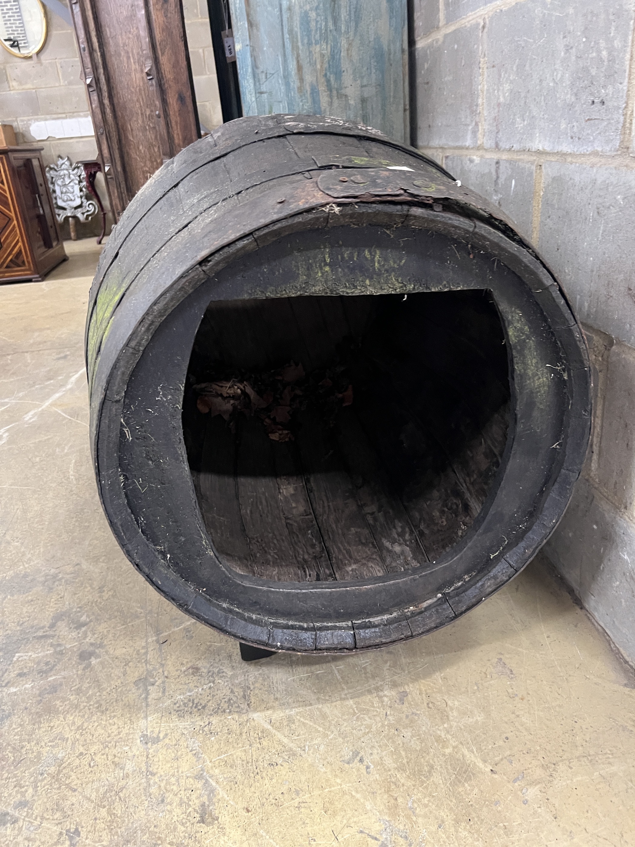 A vintage coopered wine barrel on stand, now converted to a dog's kennel, width 96cm, height 76cm